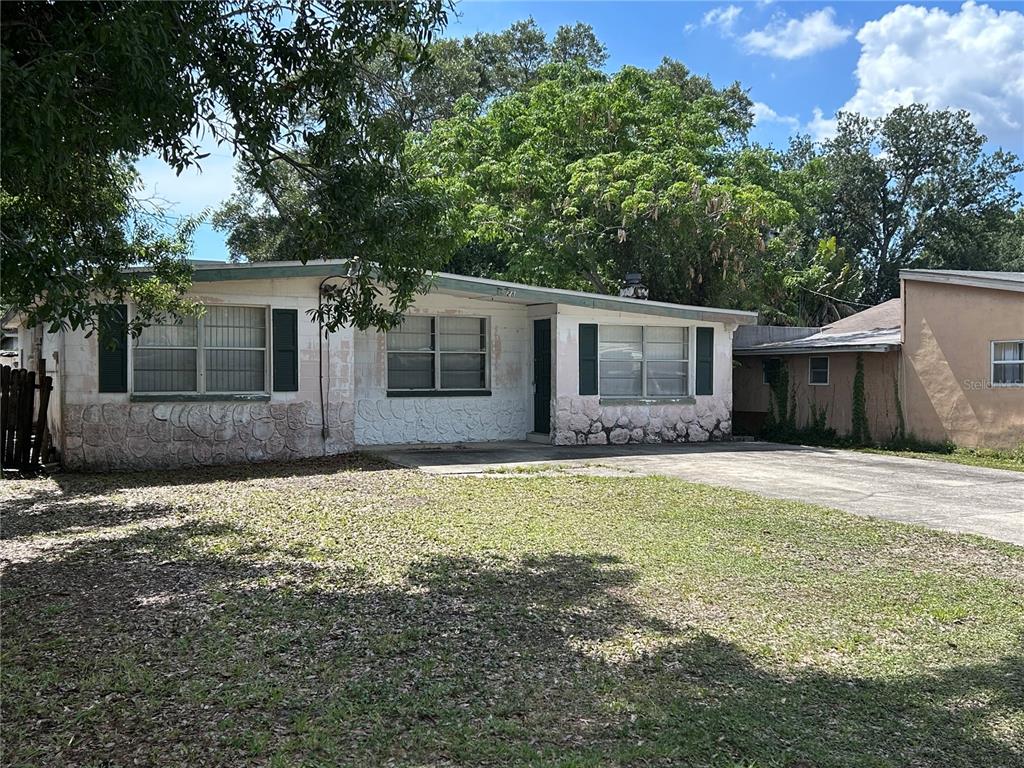 A single-story house with a stone-textured base, white siding, and a concrete driveway — 6328 30TH WAY N, ST PETERSBURG, FL