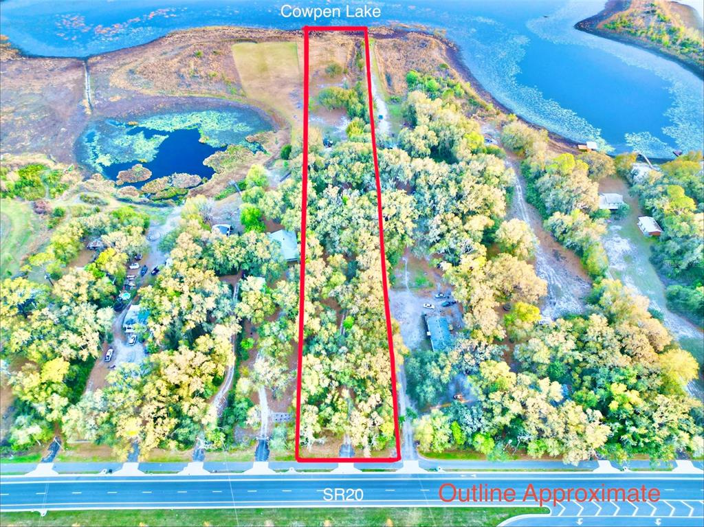 An aerial view shows a long, narrow rectangular plot of land extending from SR20 to Cowpen Lake — 1837 STATE ROAD 20, HAWTHORNE, FL