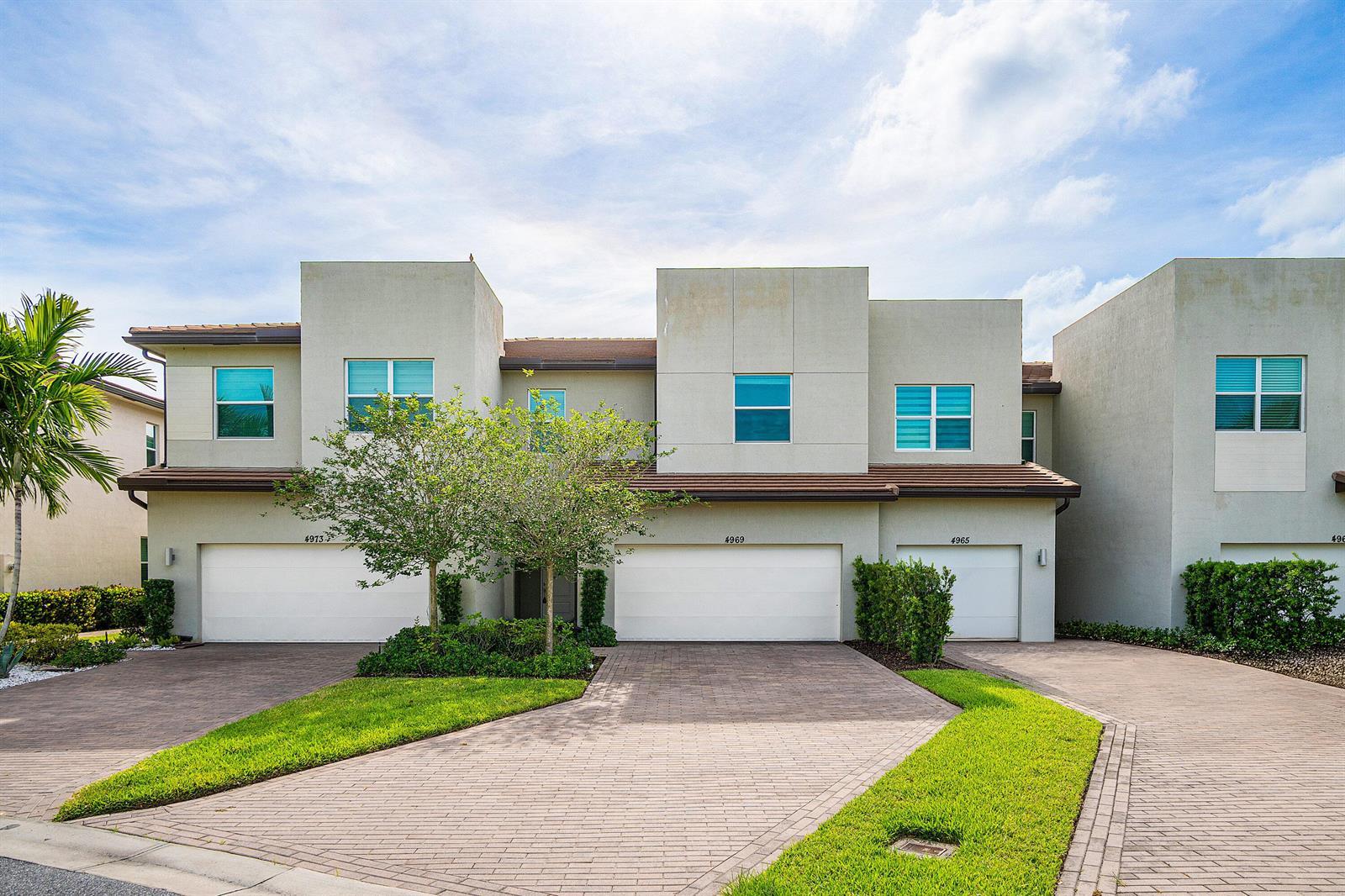 A multi-unit residential building with beige stucco walls, brown tiled roofs, and paved driveways — 4969 Navali Drive, Lake Worth FL 33467, LAKE WORTH, FL