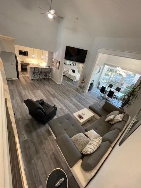 An elevated view of an open-concept living room and kitchen with gray wood-look flooring — 3602 Fairway Drive N, Jupiter FL 33477, JUPITER, FL