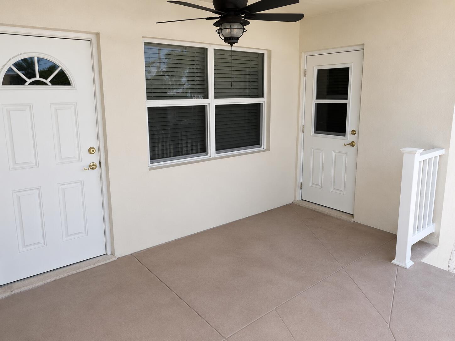 A covered patio features a ceiling fan, two white doors, a window, and tiled flooring — 1221 SE 3rd Street # 4, Deerfield Beach FL 33441, DEERFIELD BEACH, FL