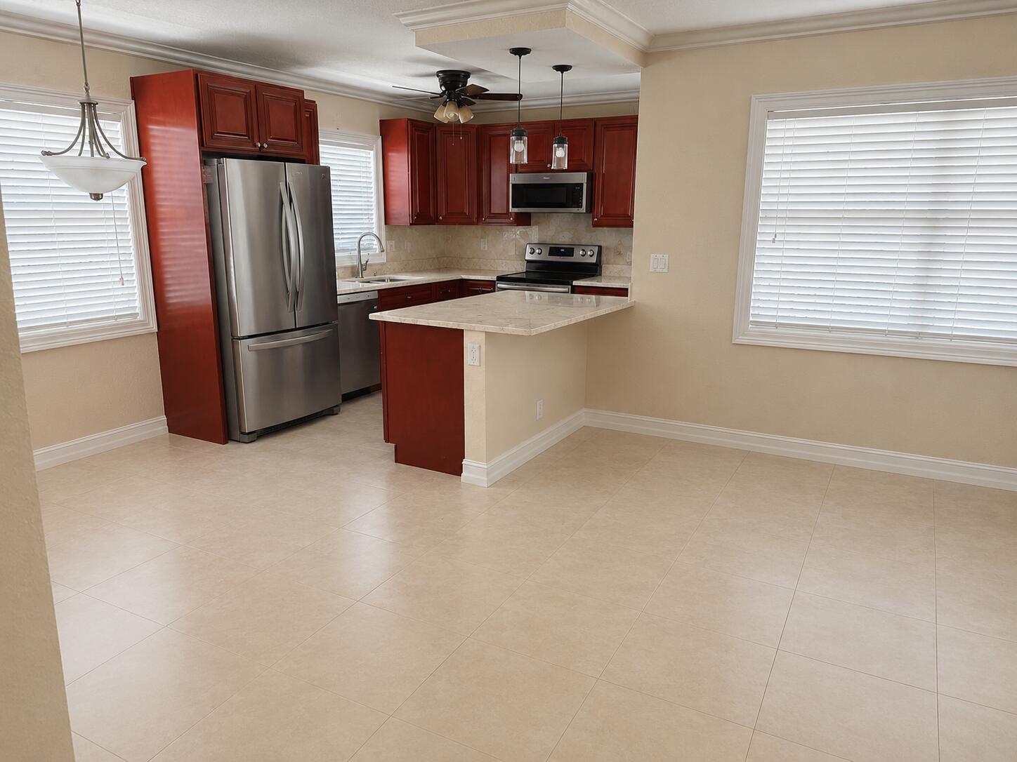 A kitchen with cherry wood cabinets, stainless steel appliances, and a peninsula counter — 1221 SE 3rd Street # 4, Deerfield Beach FL 33441, DEERFIELD BEACH, FL