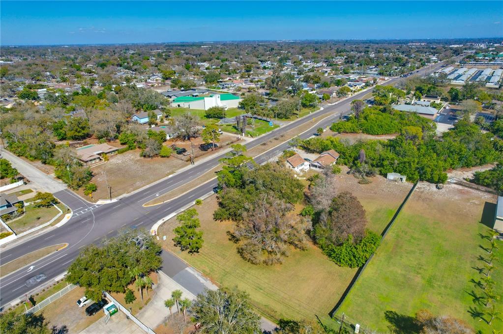 An aerial view shows a multi-lane road running through a suburban area with green lots — 12750 PARK BOULEVARD, SEMINOLE, FL