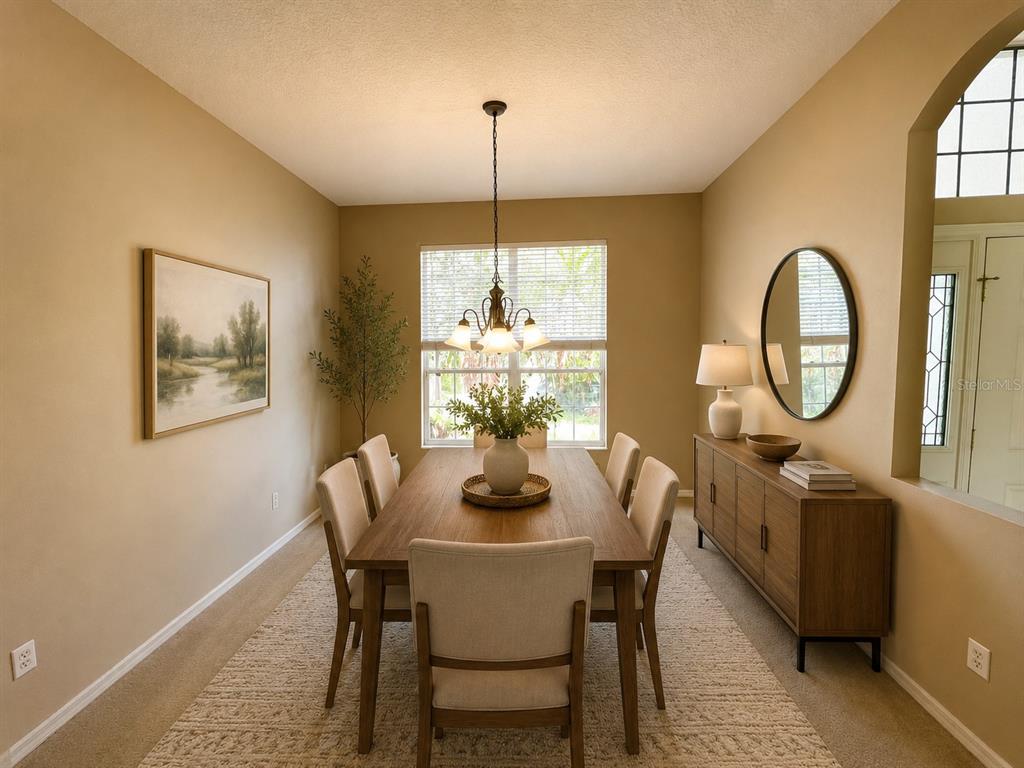 A dining room features a wooden table, six upholstered chairs, a sideboard, and a chandelier — 5336 TIDEWATER STREET, LEESBURG, FL