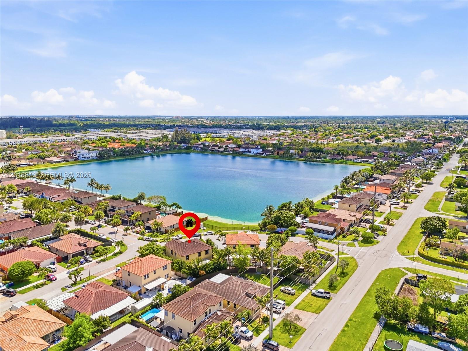 A living and dining area features tile floors, brown leather furniture, and a patterned rug — 12921 SW 281st St, Homestead FL 33033, HOMESTEAD, FL