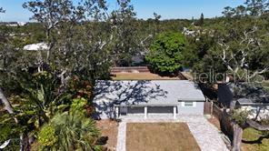 An aerial view of a single-story house with a gray roof and a paved driveway — 1408 ROGERS STREET, CLEARWATER, FL