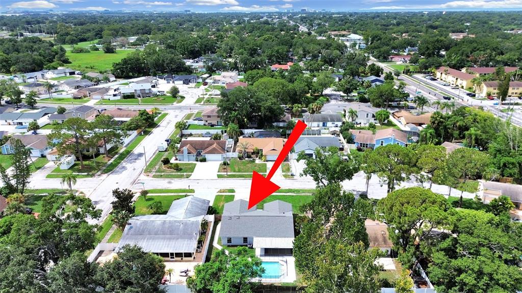 An aerial view shows a residential house with a gray roof and a backyard pool — 7513 MAYFAIR COURT, TAMPA, FL