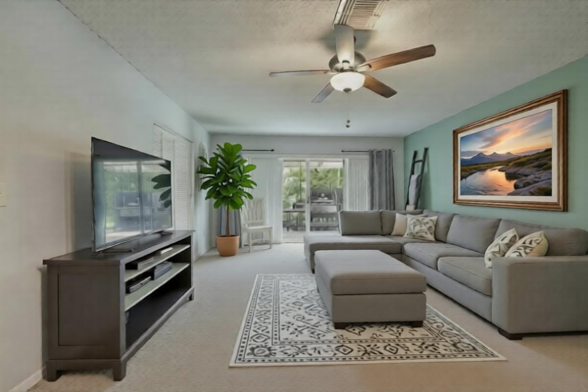 A living room features a gray sectional sofa, a television console, and a ceiling fan — 6309 Summer Sky Lane, FL 33463, FL