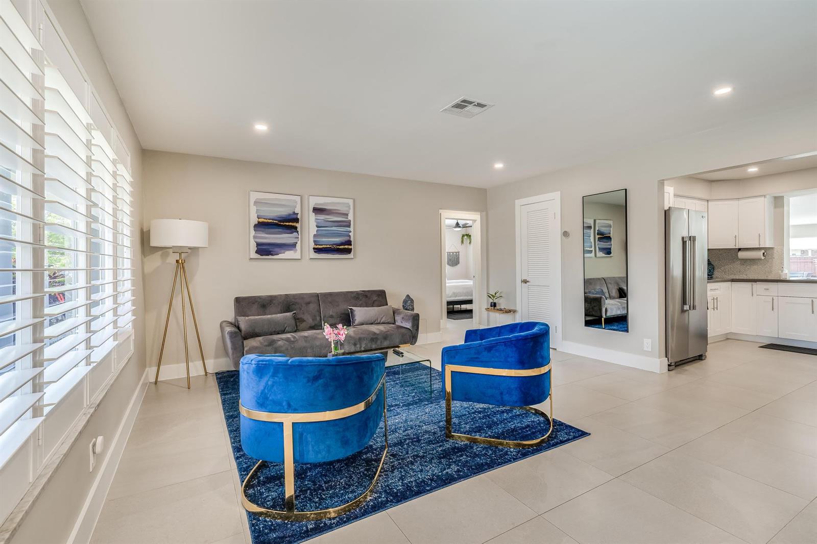 A living room features a grey sofa, two blue velvet chairs, and a blue rug — 300 SE 8th Court, Pompano Beach FL 33060, POMPANO BEACH, FL
