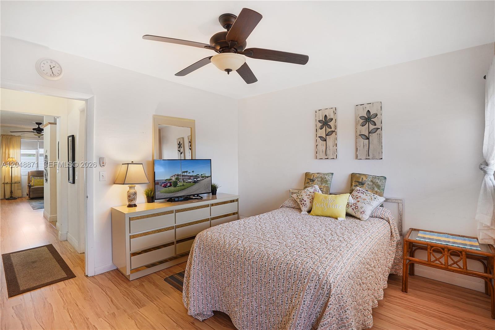 A bedroom features a bed, a dresser with a television, and a ceiling fan — 820 SW 11th Ave # 18B, Hallandale Beach FL 33009, HALLANDALE BEACH, FL