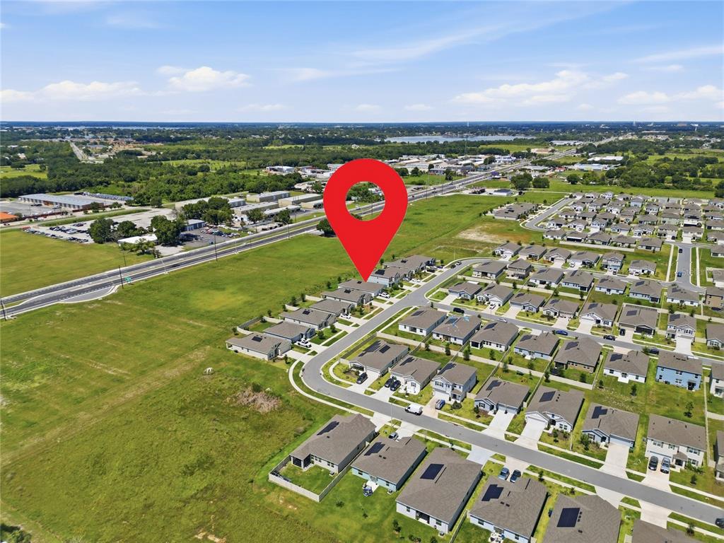 An aerial view shows a residential neighborhood with a red location pin marking a house — 680 GROVE STREET, WINTER HAVEN, FL