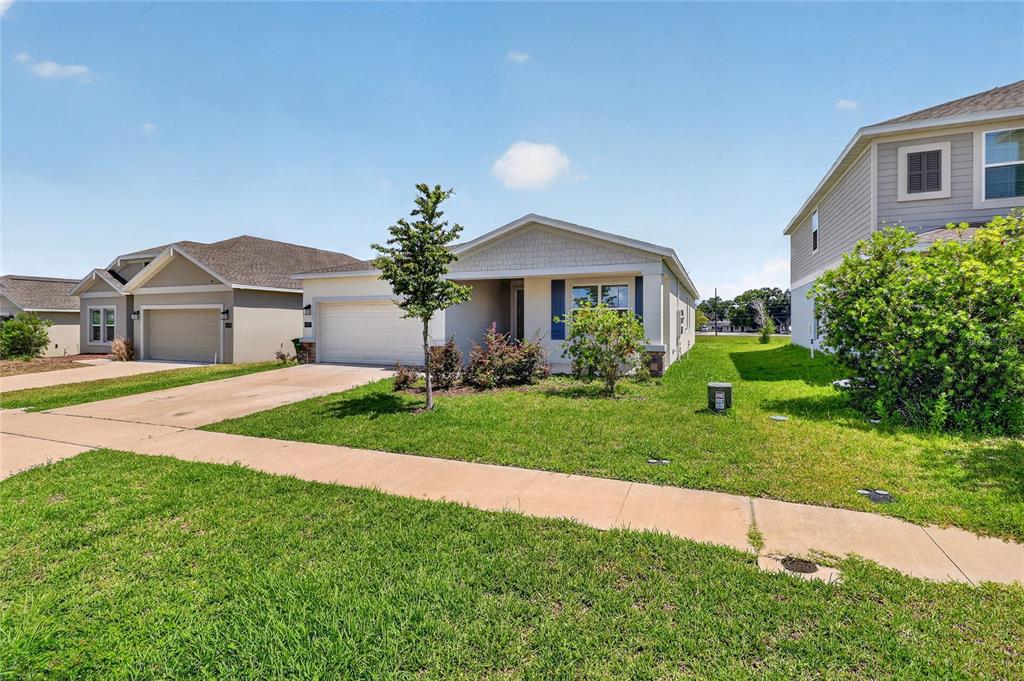 A single-story suburban house with a two-car garage and a front lawn — 680 GROVE STREET, WINTER HAVEN, FL