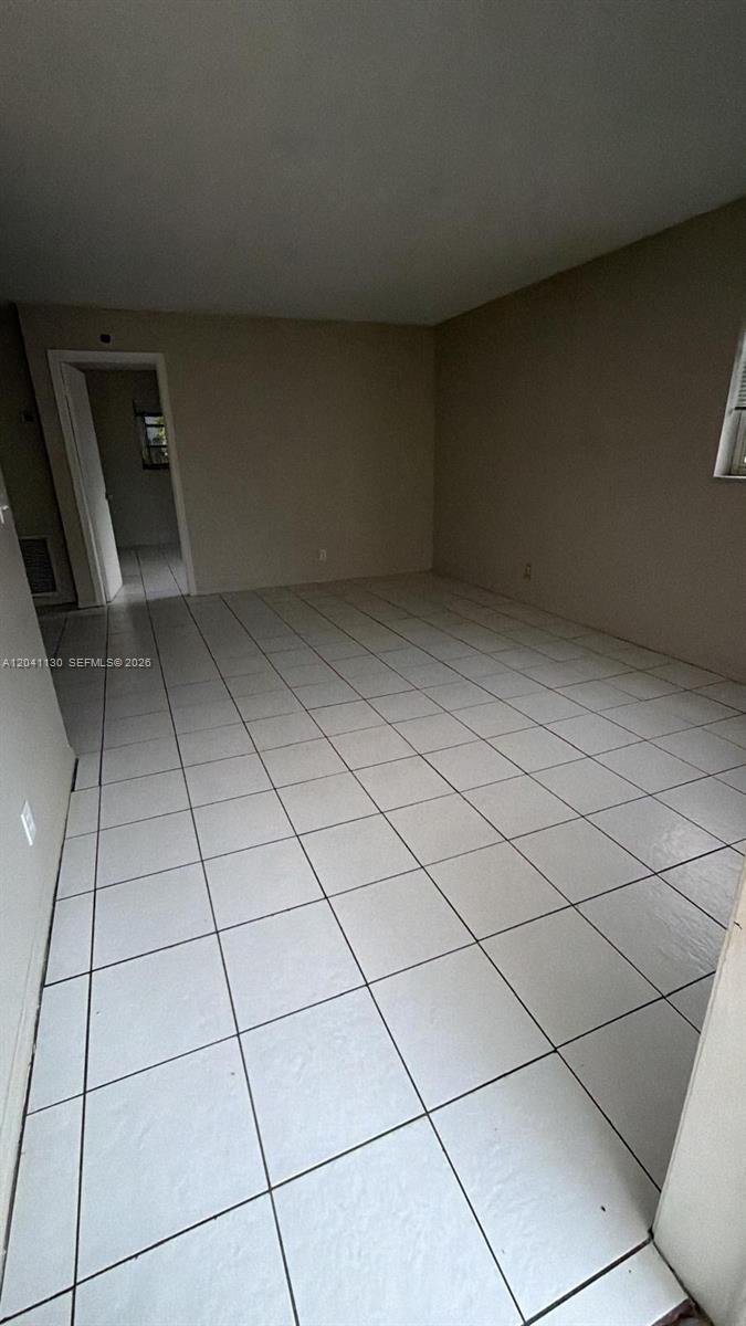 An empty room features light-colored square floor tiles and plain, neutral-toned walls — 314 S J St # 4, Lake Worth FL 33460, LAKE WORTH, FL