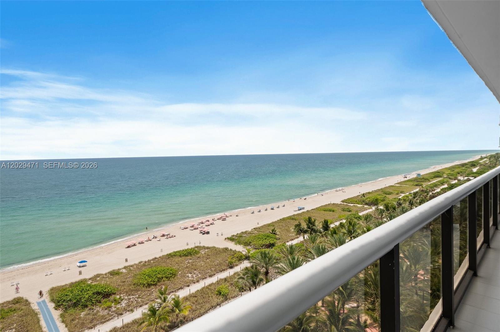 A high-angle view of a sandy beach and ocean from a balcony — 9455 Collins Ave # 1208, Surfside FL 33154, SURFSIDE, FL