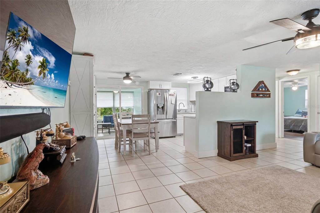 An open-concept living area features a kitchen, dining space, and tiled floors — 60 S LINCOLN AVENUE, BEVERLY HILLS, FL