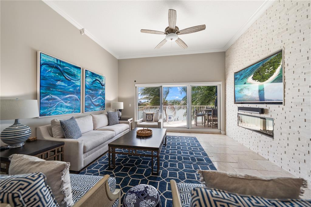 A swimming pool with a brick deck overlooks a bay with boat docks and buildings — 205 BRIGHTWATER DRIVE UNIT 205, CLEARWATER BEACH, FL