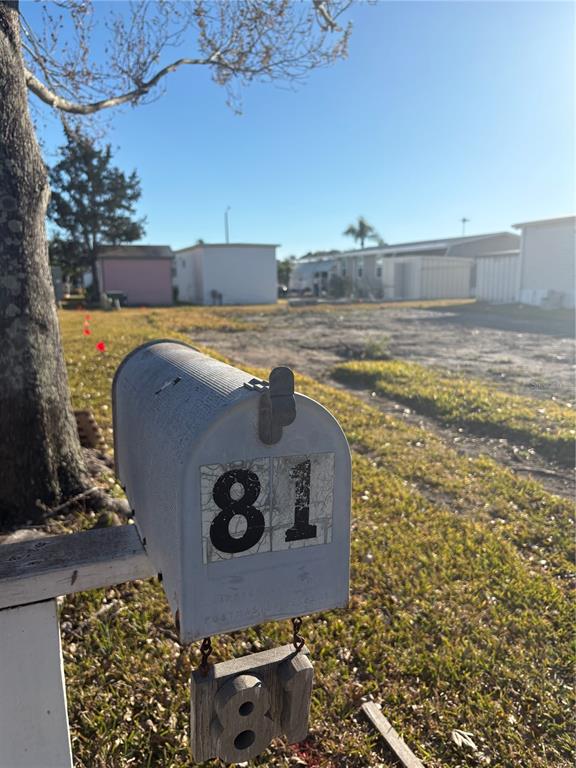 A mailbox labeled with the number 81 stands in front of a vacant residential lot — 11300 124TH AVENUE UNIT 81, LARGO, FL