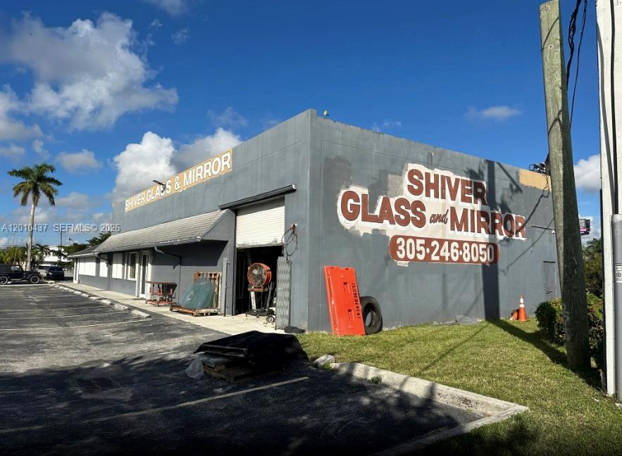 The exterior of a gray commercial building features signage for Shiver Glass and Mirror — 10 NE 3rd St, Florida City FL 33034, FLORIDA CITY, FL
