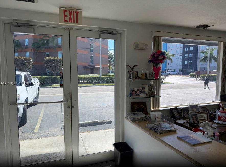 A view from inside an office looking out through glass doors and a large window — 10 NE 3rd St, Florida City FL 33034, FLORIDA CITY, FL