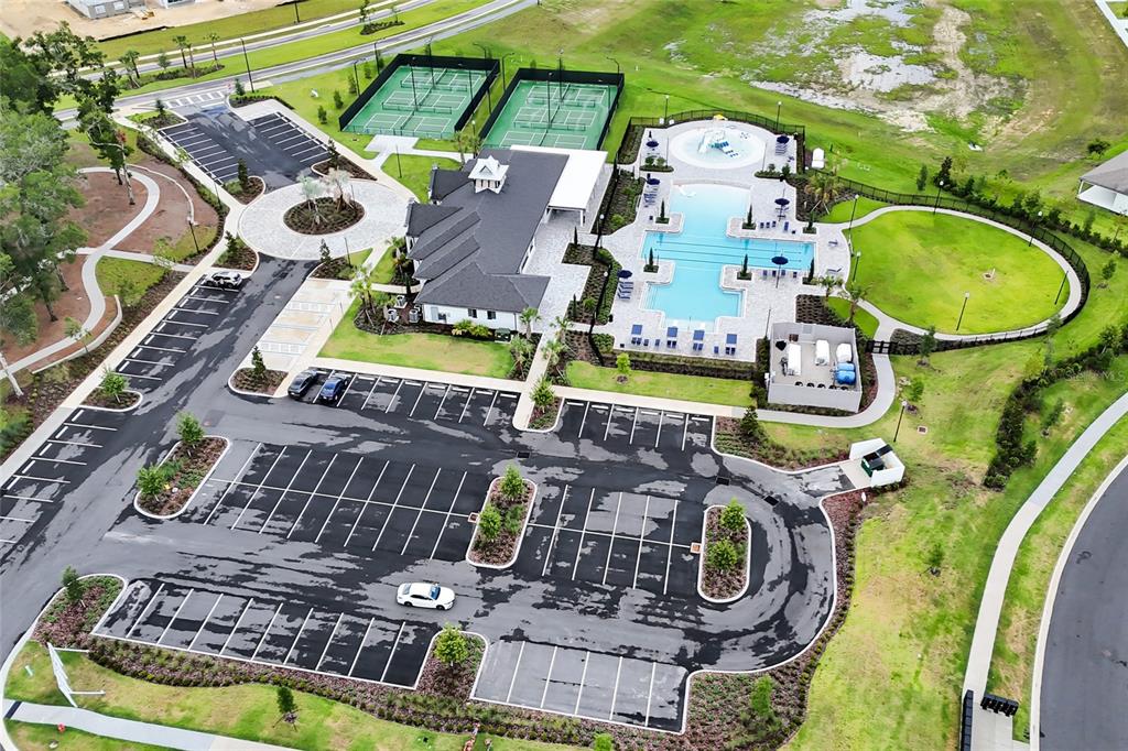 An aerial view shows a community clubhouse with a swimming pool, tennis courts, and parking — 4637 SW 84TH STREET ROAD, OCALA, FL