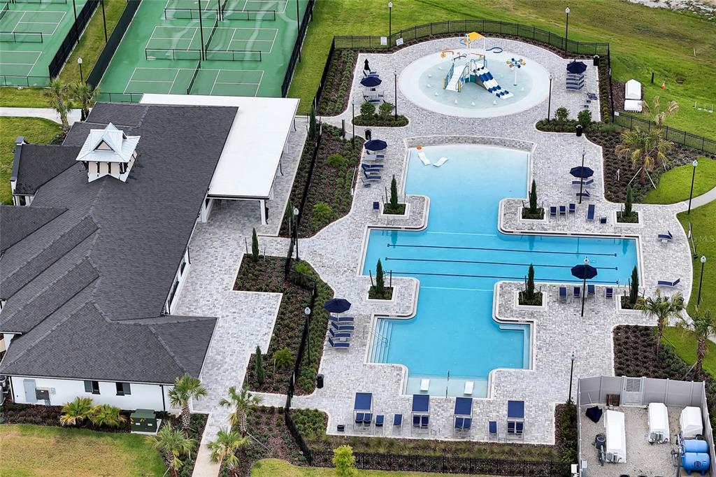 An aerial view shows a community clubhouse with a swimming pool, splash pad, and tennis courts — 4637 SW 84TH STREET ROAD, OCALA, FL