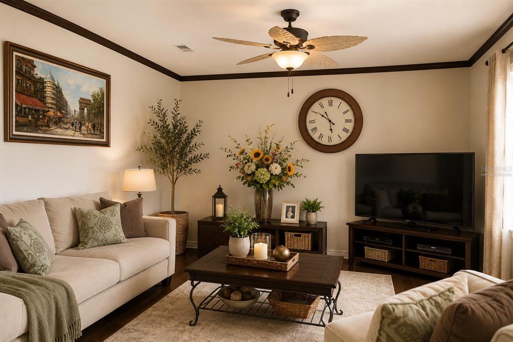 A living room features a beige sofa, a dark wood coffee table, and a wall-mounted clock — 2915 SOUTHERN PINES LOOP, CLERMONT, FL