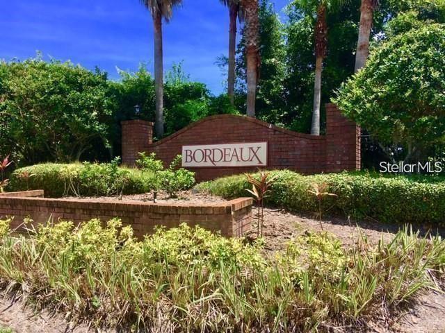 A brick entrance sign for a community named Bordeaux sits among landscaping and palm trees — 2015 ERVING CIRCLE UNIT 304, OCOEE, FL
