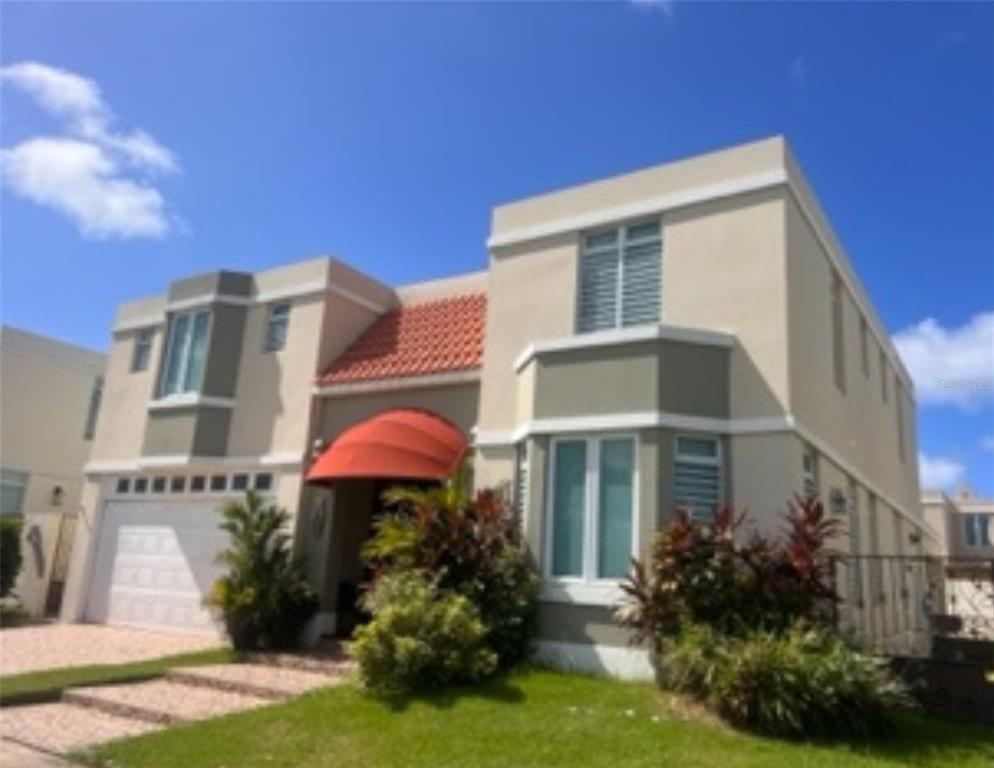 A two-story house with a tan stucco exterior, a red awning, and a tiled roof — Mar Caspio M-6 PASEO LOS CORALES 2, DORADO, PR