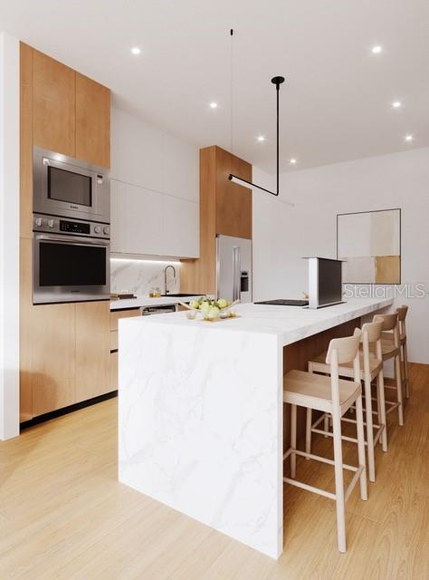 This is a rendering of a modern kitchen featuring light wood cabinetry and a marble island — 2170 ROBINHOOD STREET UNIT C1-202, SARASOTA, FL