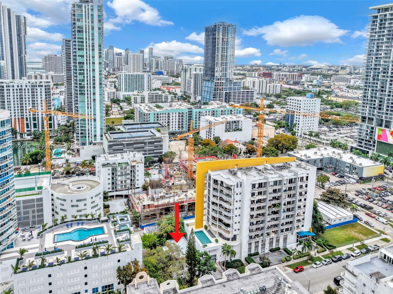 An aerial view shows a dense urban neighborhood with high-rise buildings, construction sites, and pools — 452 NE 30th St, Miami FL 33137, MIAMI, FL