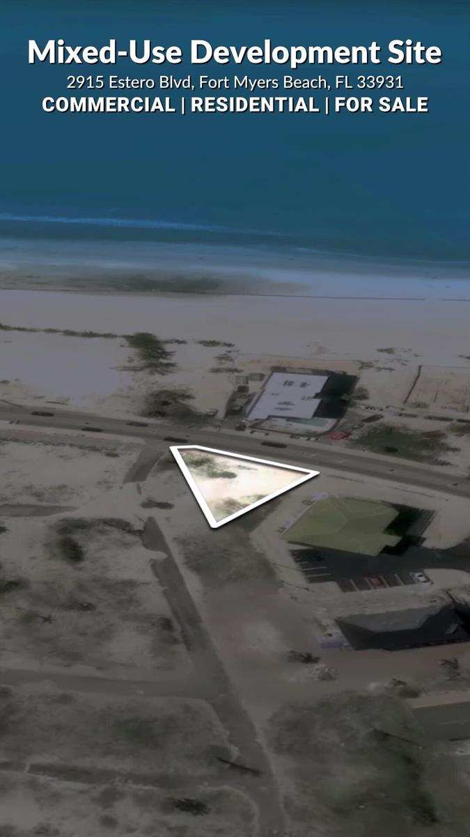 An aerial view shows a triangular vacant lot located near a beach and road — 2915 Estero Boulevard, FL 33931, FL