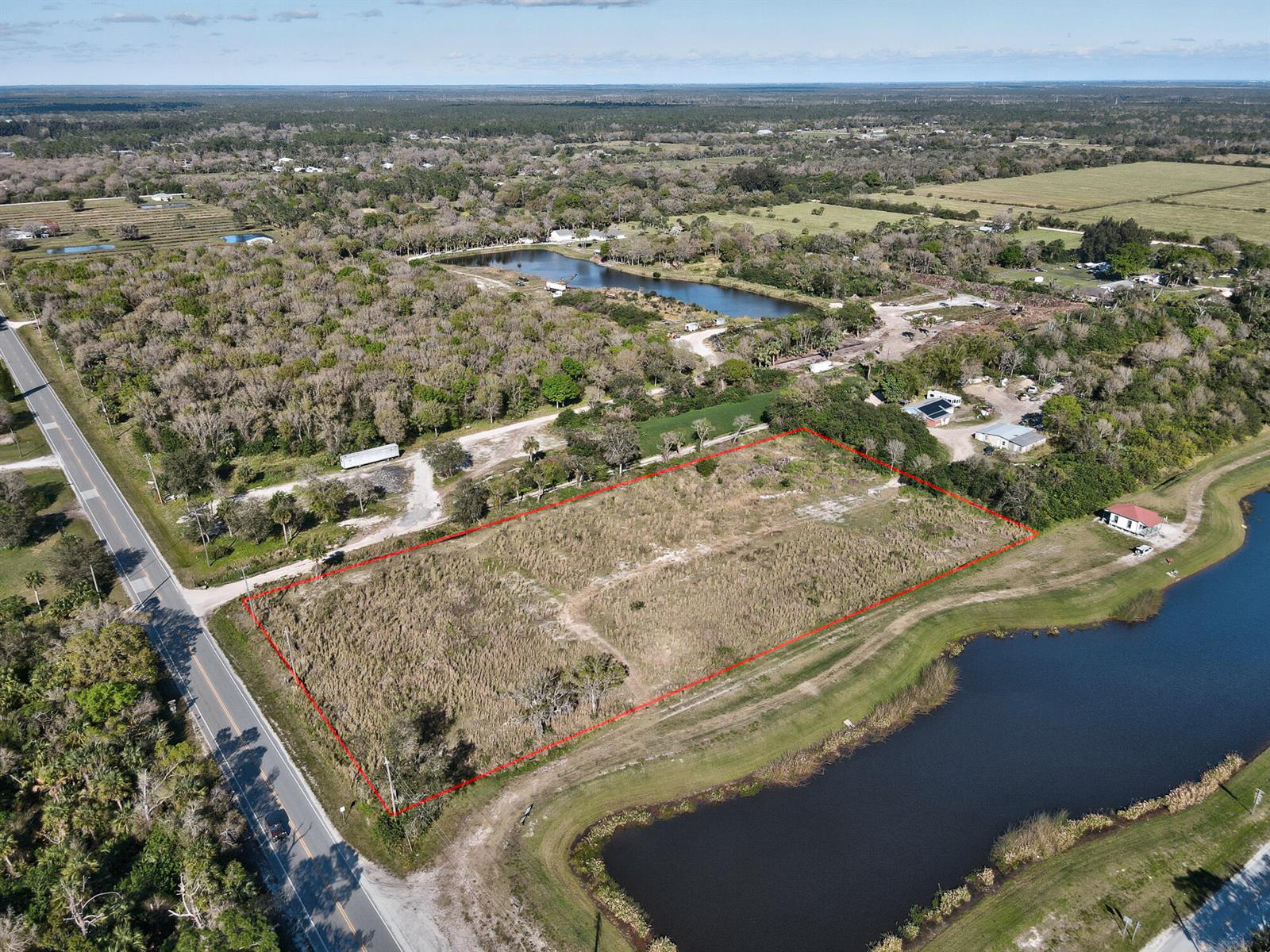 An aerial view shows a rectangular vacant lot outlined in red next to a road — 13765 99th Street, Fellsmere FL 32948, FELLSMERE, FL