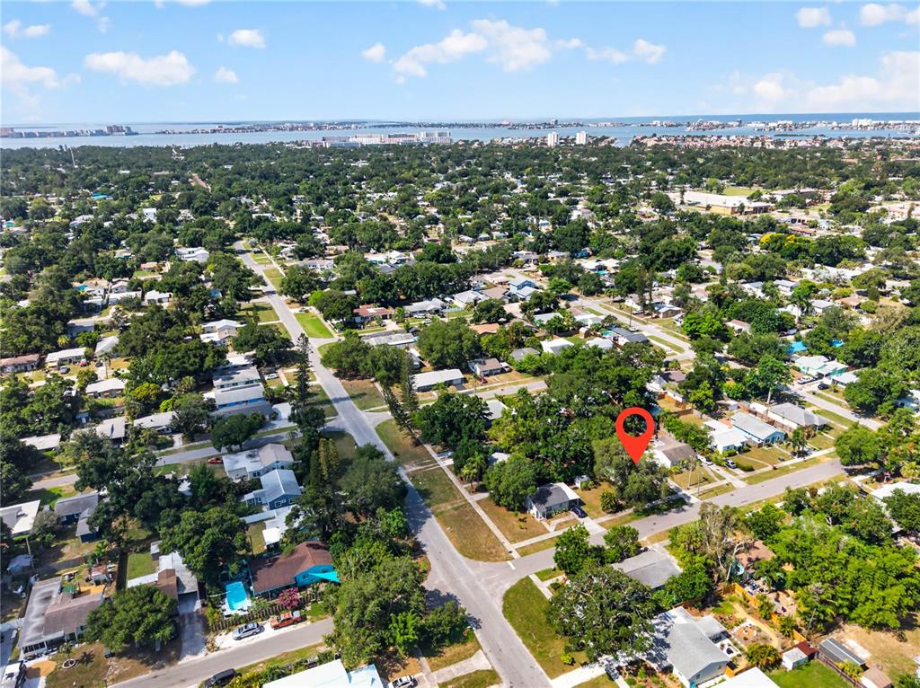 An aerial view of a residential neighborhood with a red pin marking a house — 1213 55TH STREET S, GULFPORT, FL