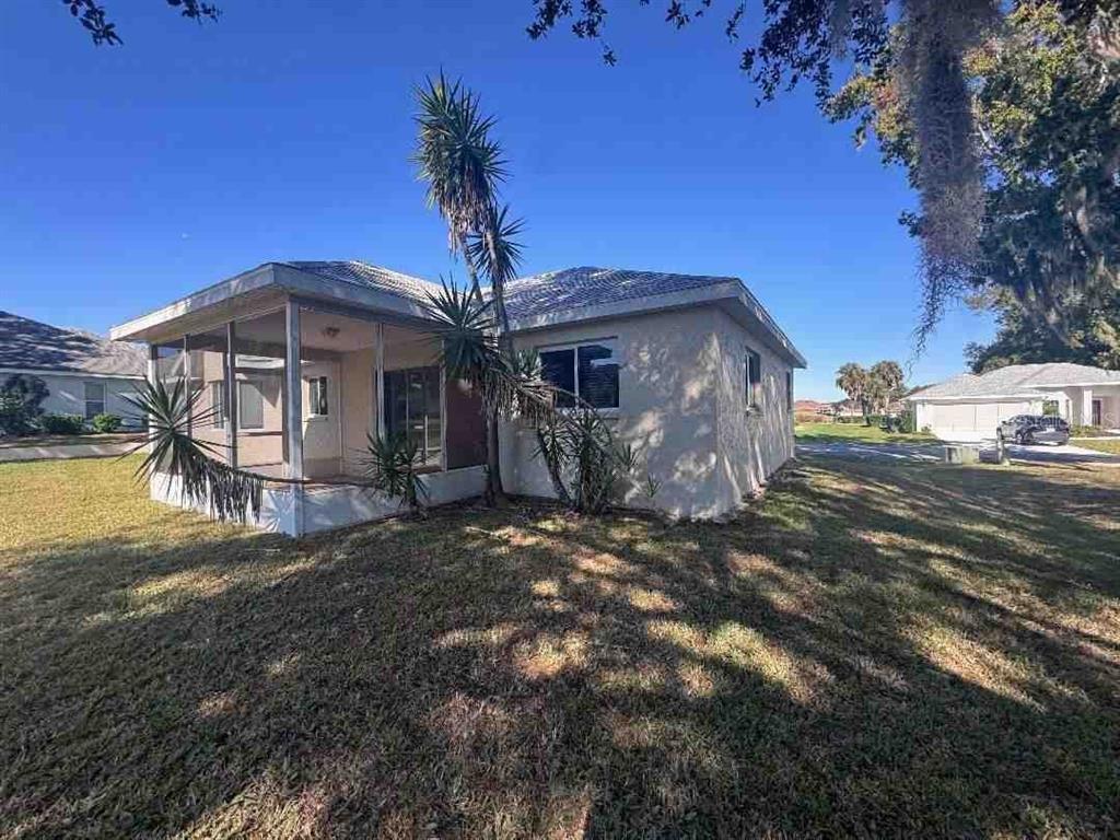 A single-story house with a screened-in porch and a tall palm tree in the yard — 5110 NW 19TH PLACE, OCALA, FL