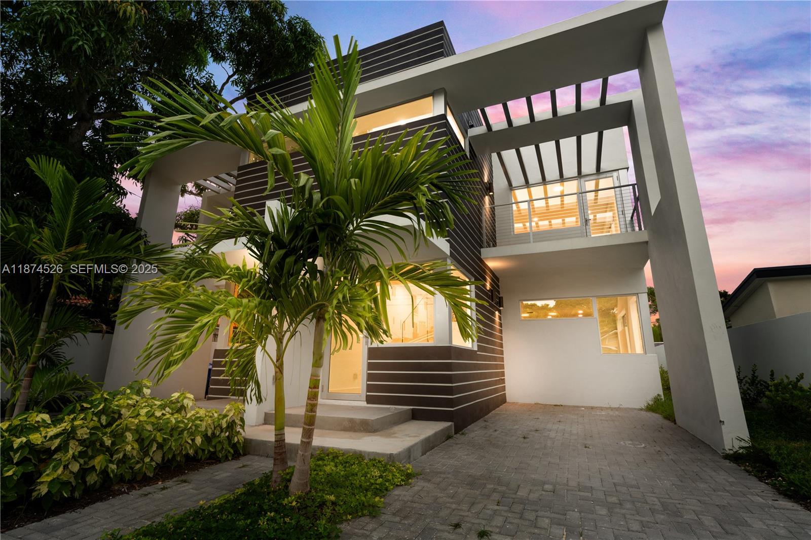 A modern two-story house with horizontal siding, a paved driveway, and a second-floor balcony — 857 SW 14th Ave # A, Miami FL 33135, MIAMI, FL