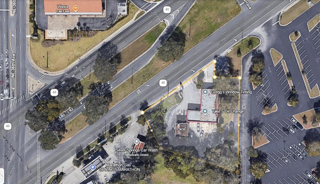 This aerial map shows a commercial property lot outlined in yellow near a busy intersection — 3680 E SILVER SPRINGS BOULEVARD, OCALA, FL