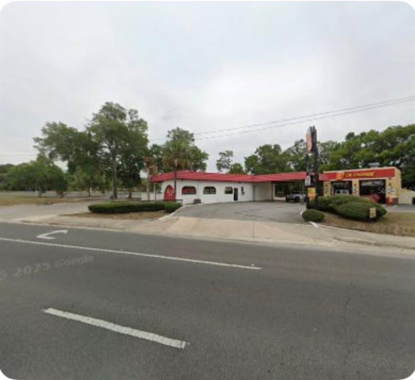 A single-story commercial building with a red roof and a drive-thru lane — 3680 E SILVER SPRINGS BOULEVARD, OCALA, FL