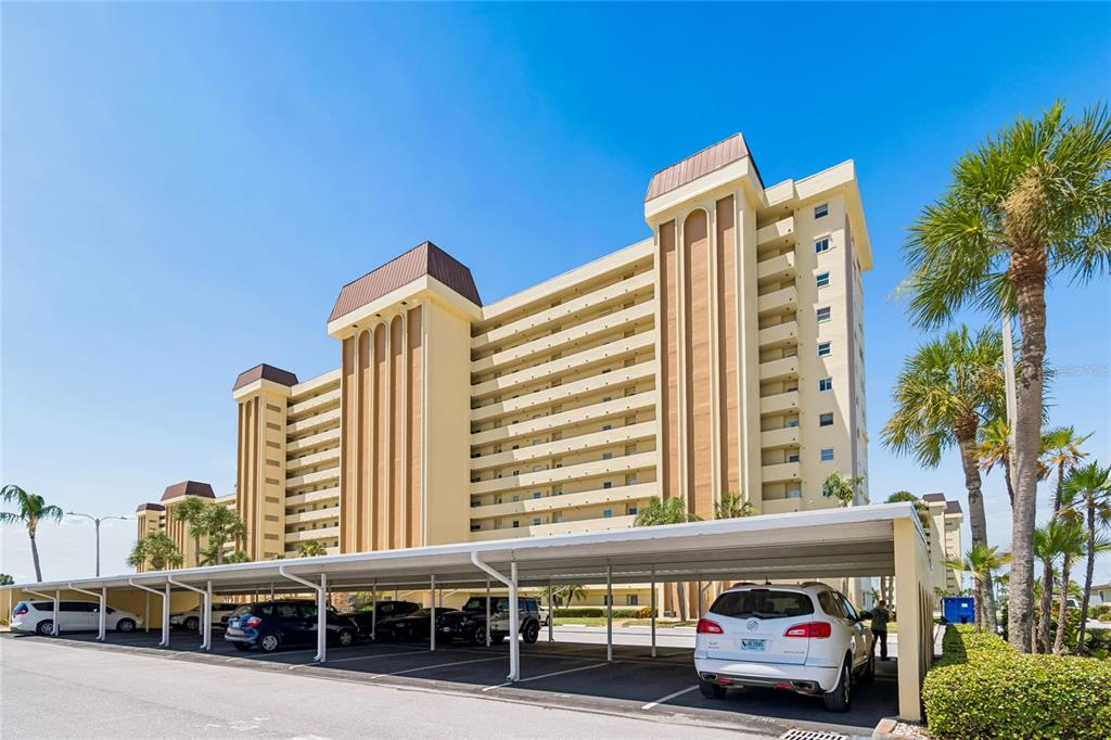 A multi-story apartment building with a covered parking structure in the foreground — 4575 COVE CIRCLE UNIT 101, ST PETERSBURG, FL