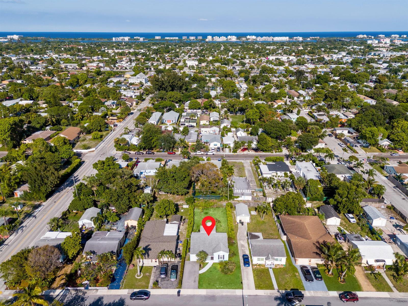 An aerial view shows a single-story house with a red location pin in a residential neighborhood — 620 N B Street, FL 33460, FL