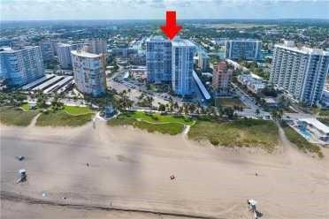 An aerial view shows a high-rise residential building on a sandy beach — 405 N Ocean Boulevard # 1123, Pompano Beach FL 33062, POMPANO BEACH, FL