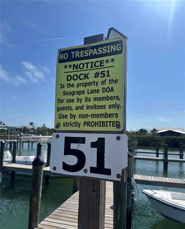 A sign on a wooden post identifies dock number 51 as private property — 8992 SEAGRAPE LANE, PLACIDA, FL