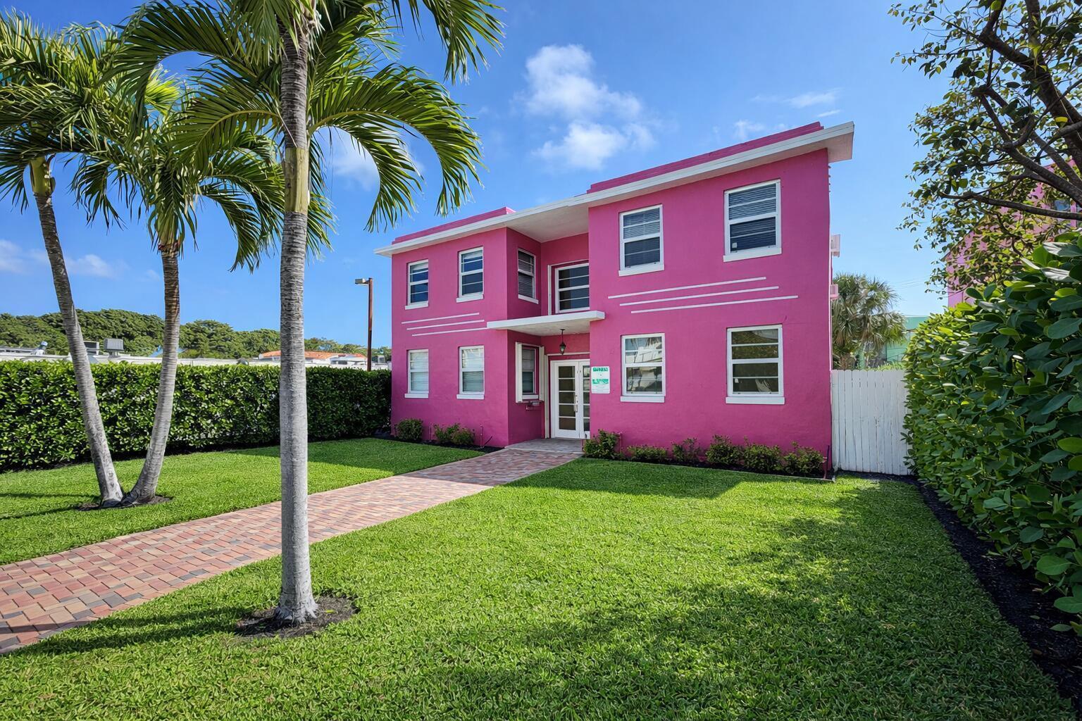 A bright pink two-story building with a brick walkway and palm trees on a lawn — 14 S M Street # 3, FL 33460, FL