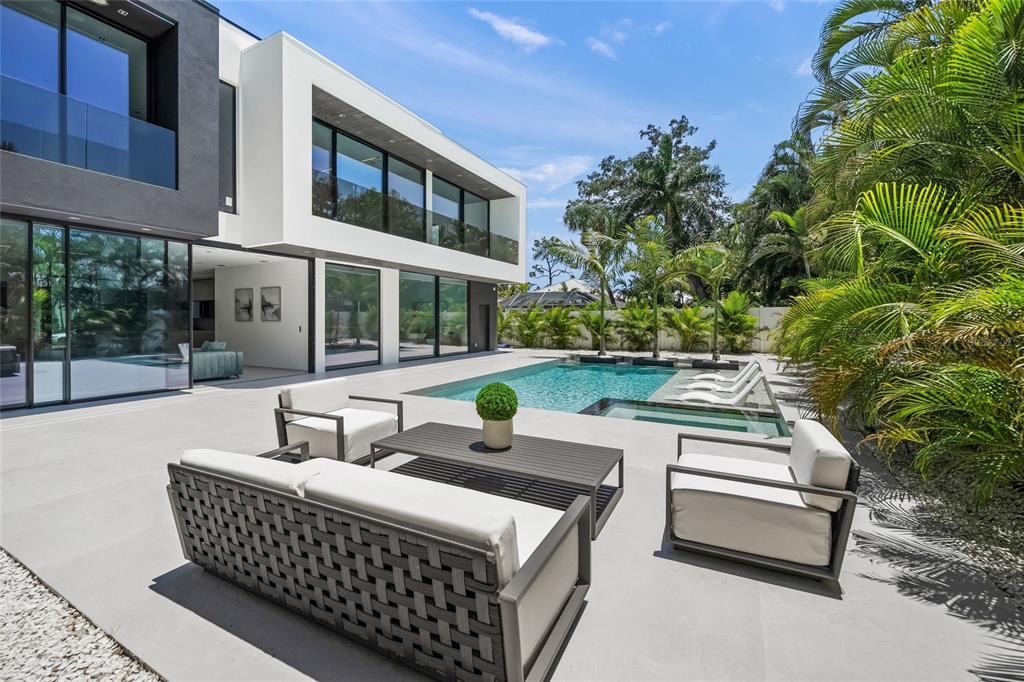A modern two-story home with a patio, outdoor seating, and a swimming pool — 1640 WALDEMERE STREET, SARASOTA, FL