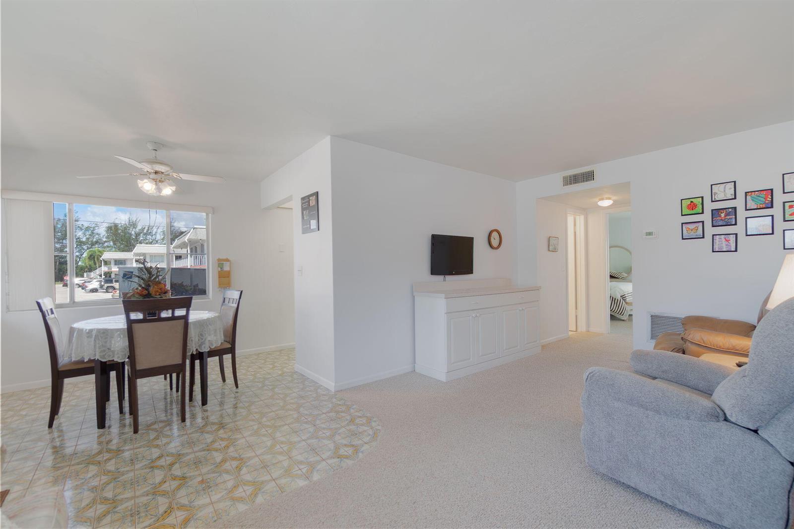 A living and dining area features tiled and carpeted floors, white walls, and a ceiling fan — 2840 Cynthia Lane # 101, FL 33461, FL