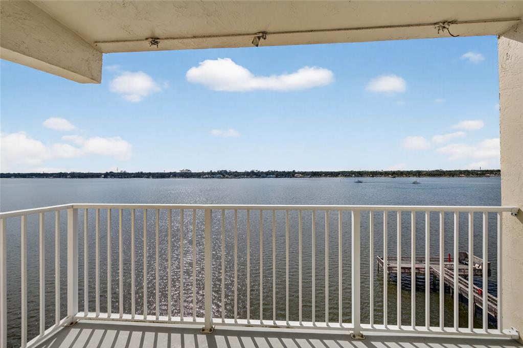 A balcony with a white metal railing overlooks a large body of water — 2711 N HALIFAX AVENUE UNIT 695, DAYTONA BEACH, FL