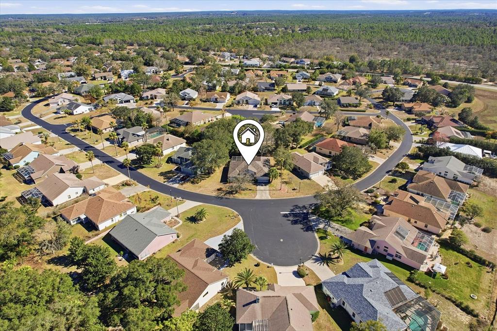 An aerial view shows a suburban neighborhood with a house marked by a location pin — 5628 W HUNTERS RIDGE CIRCLE, LECANTO, FL