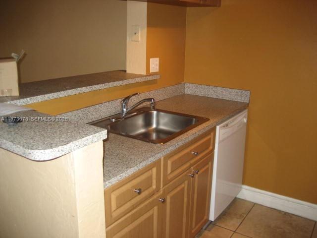 A kitchen features a stainless steel sink, light wood cabinets, and speckled granite countertops — 10832 N KENDALL DR # 6, Miami FL 33176, MIAMI, FL