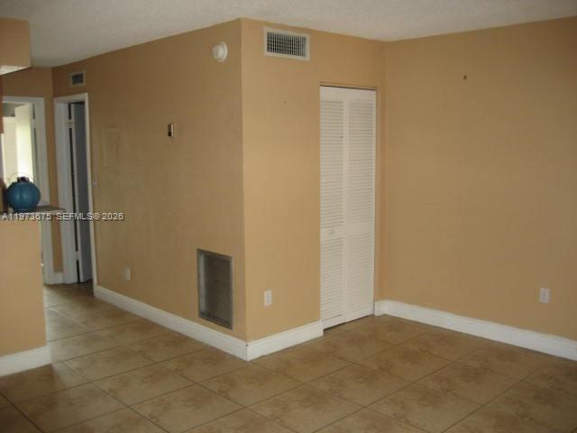 An interior view showing a beige room with tiled floors, a closet, and a doorway — 10832 N KENDALL DR # 6, Miami FL 33176, MIAMI, FL
