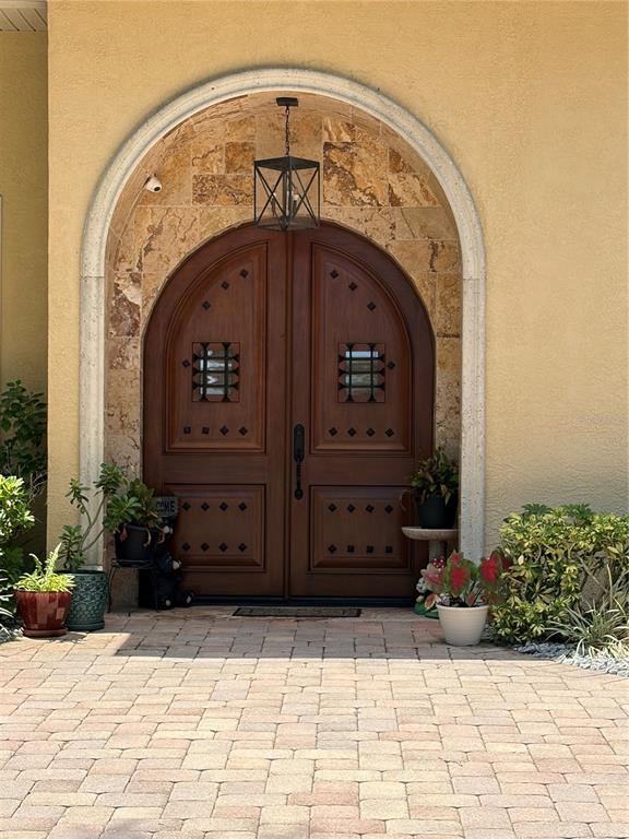 A single-story house with a paved driveway and a garage at dusk — 4205 CREMONA COURT, SEBRING, FL