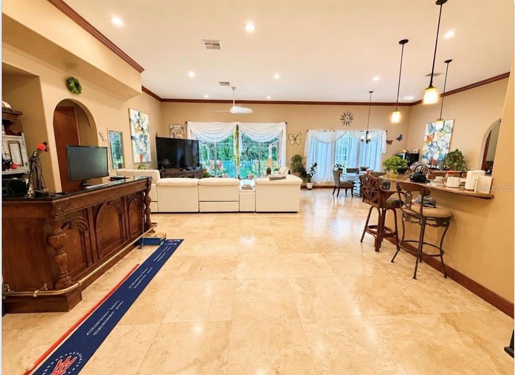A stone-arched entryway features double wooden doors with iron accents and a hanging lantern — 4205 CREMONA COURT, SEBRING, FL